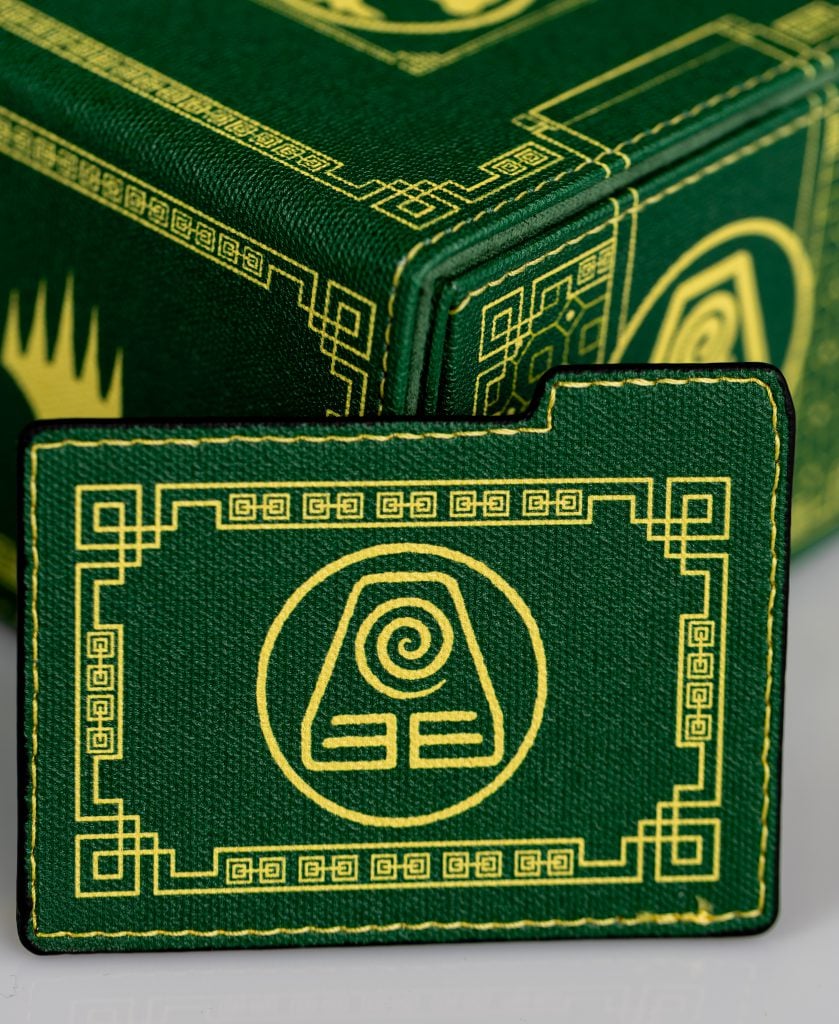 Green DOMARU Avatar deck box with its earthbending symbol divider