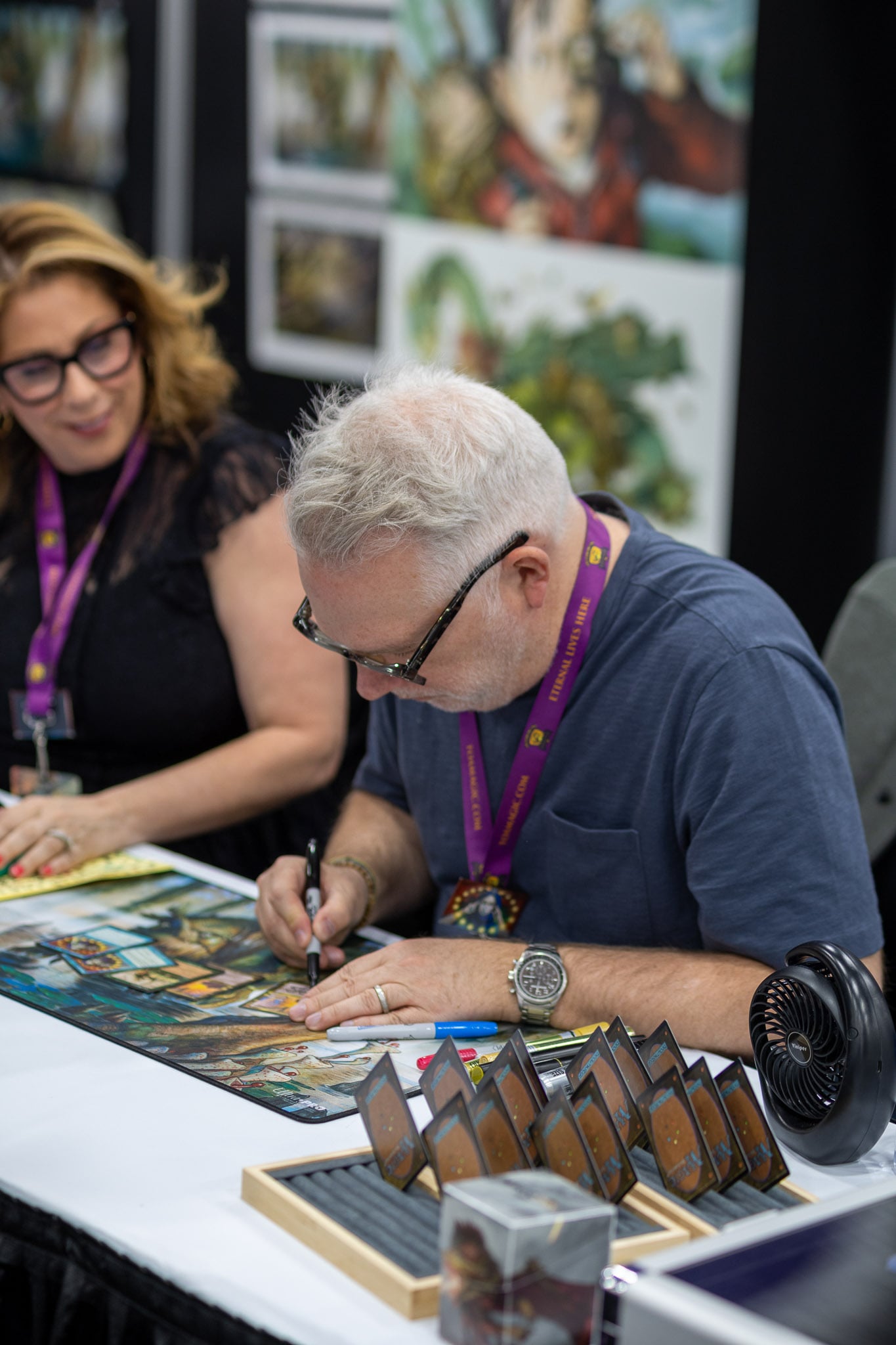 Tony DiTerlizzi signs while his wife Angela - the original model/inspiration for the art of Brainstorm - looks on.